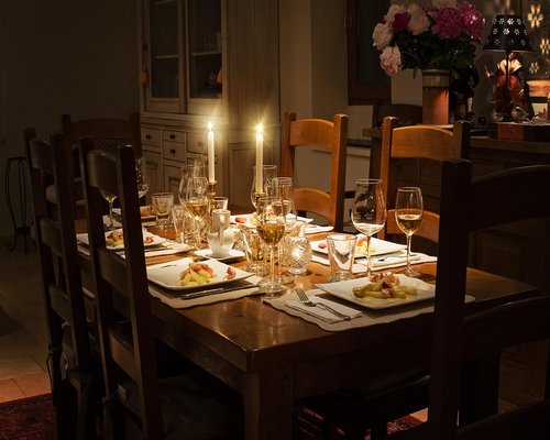 A family dining together sharing home cooked meals around a warmly lit dining table
